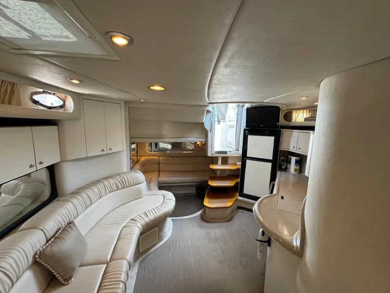 Slide: The Image of Interior of 1999 Sea Ray 380 Sundancer yacht with elegant seating and modern amenities. - 24