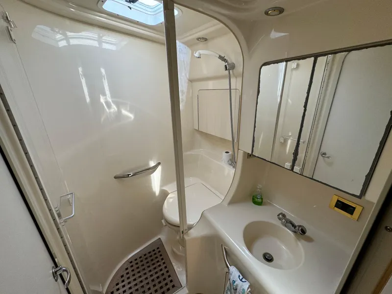 Slide: The Image of 1999 Sea Ray 380 Sundancer bathroom with shower, sink, and mirror. - 25