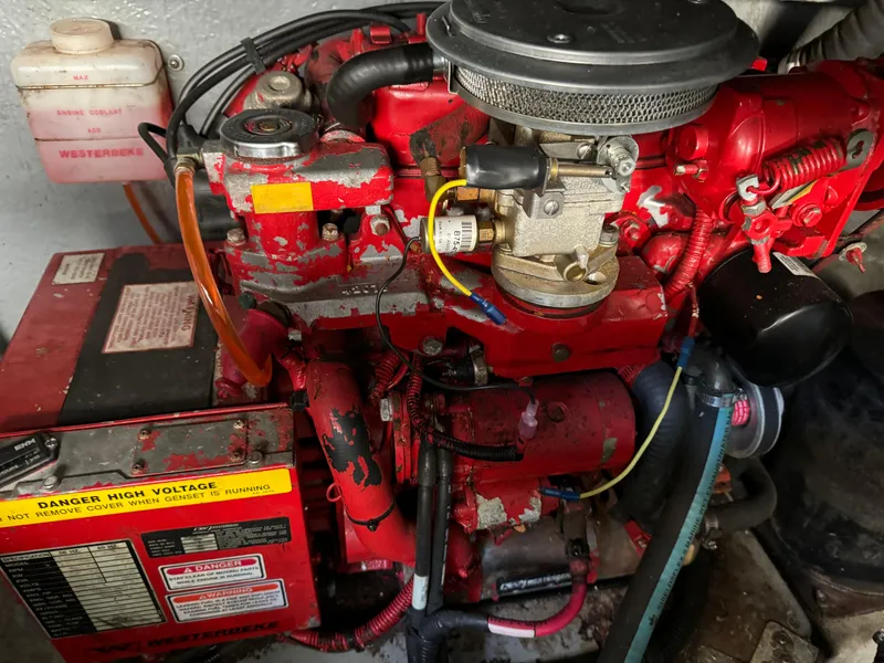 Slide: The Image of Engine compartment of a 1999 Sea Ray 380 Sundancer, featuring a red marine engine. - 28