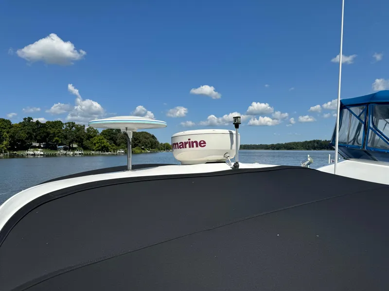 Slide: The Image of 1999 Sea Ray 380 Sundancer on calm water under a clear blue sky. - 7