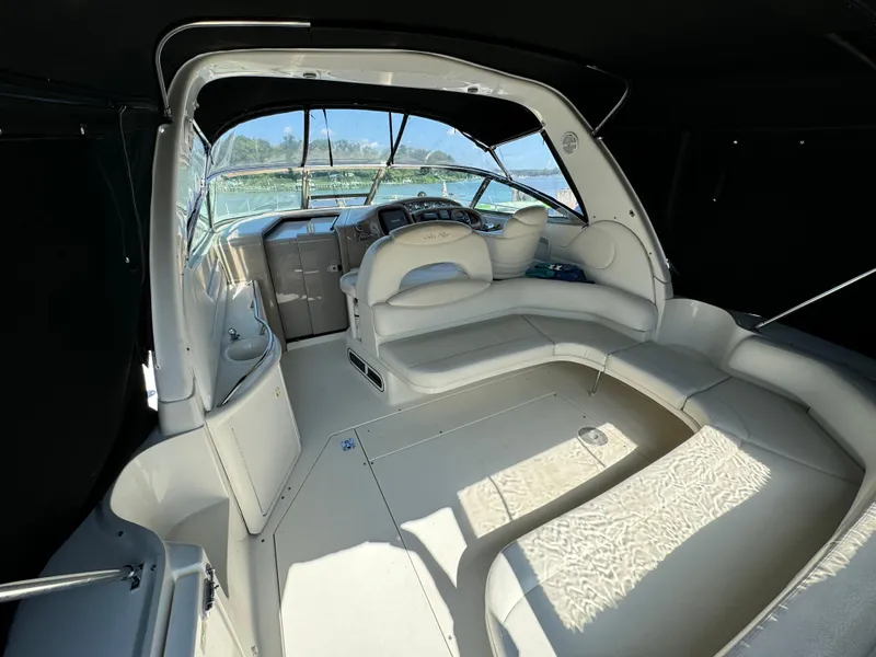 Slide: The Image of 1999 Sea Ray 380 Sundancer interior with helm and seating area, featuring elegant design. - 9