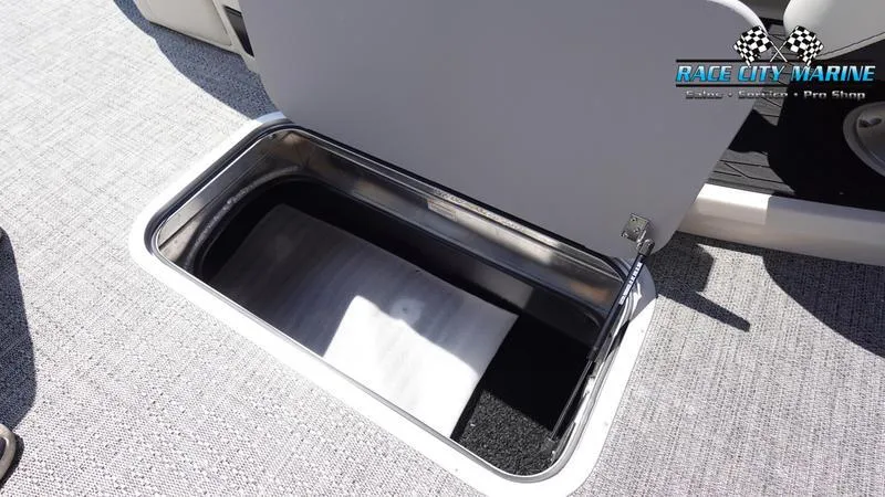 Slide: The Image of Open storage compartment on 2025 Barletta L25M boat, Race City Marine logo visible. - 36