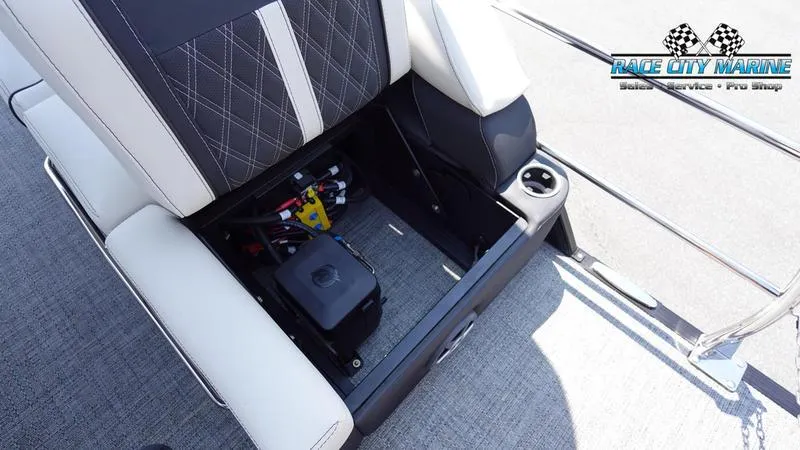 Slide: The Image of Barletta L25M 2025 boat seat storage compartment with electrical components, Race City Marine logo. - 42