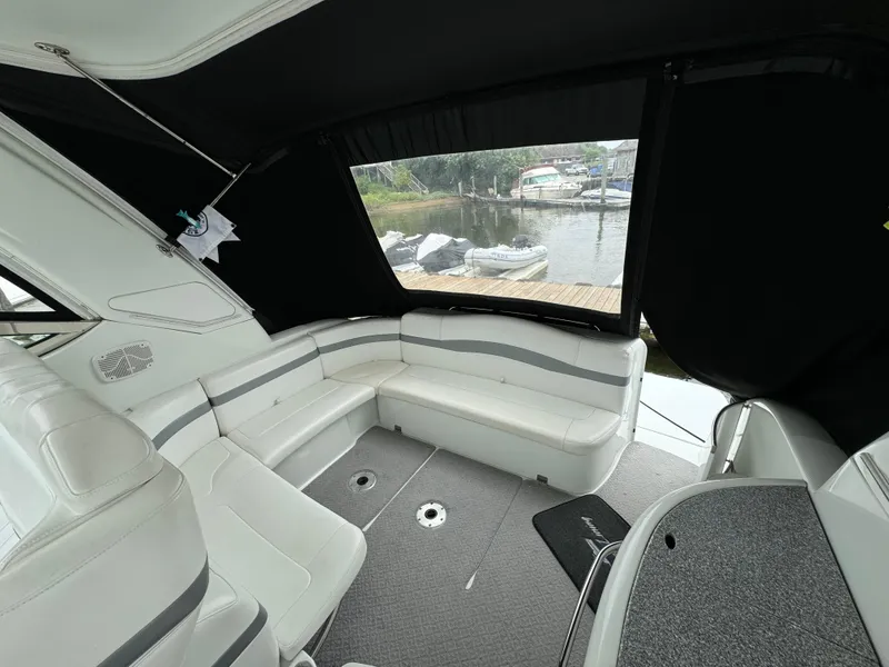 Slide: The Image of 2007 Formula 40 PC yacht interior with white seating and marina view. - 11