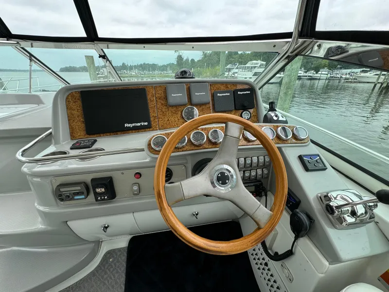 Slide: The Image of 2007 Formula 40 PC boat helm with wooden steering wheel and navigation controls. - 15