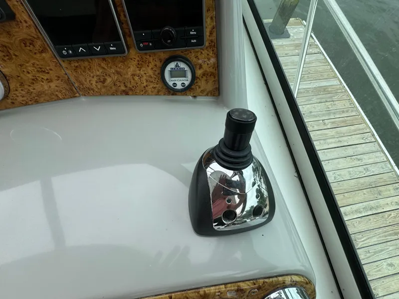 Slide: The Image of Joystick control on 2007 Formula 40 PC yacht dashboard, featuring wood paneling and gauges. - 17