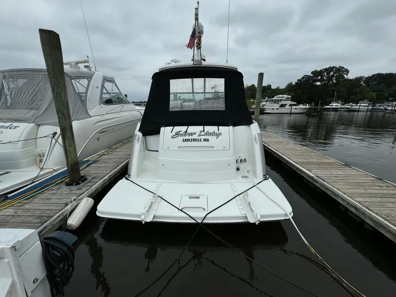 Slide: The Image of 2007 Formula 40 PC boat docked at marina, rear view with black canopy. - 2