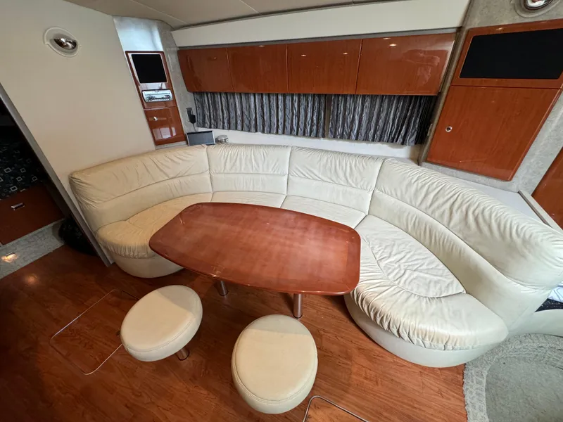 Slide: The Image of Luxurious 2007 Formula 40 PC yacht interior with curved leather seating and wooden table. - 21