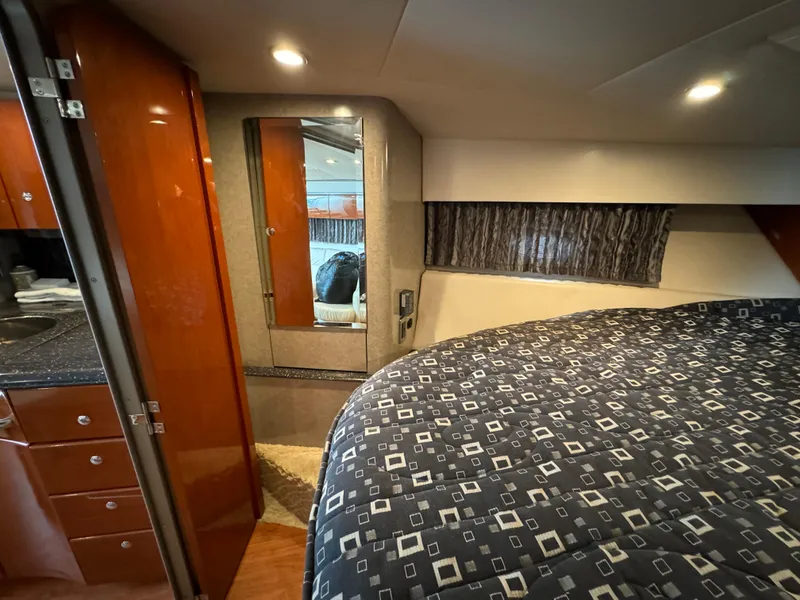 Slide: The Image of 2007 Formula 40 PC cabin interior with bed, mirror, and wooden cabinetry. - 25