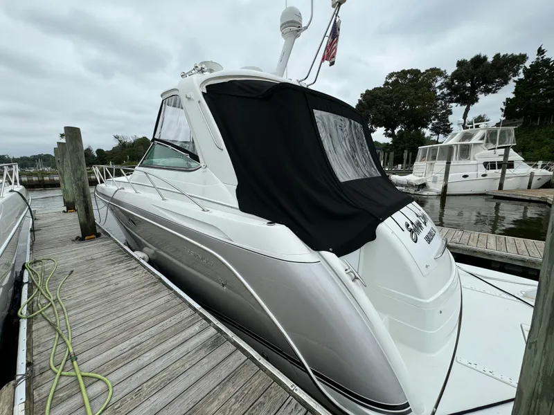 Slide: The Image of 2007 Formula 40 PC yacht docked at marina, featuring sleek design and covered cockpit. - 3