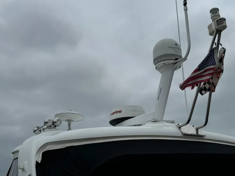 Slide: The Image of 2007 Formula 40 PC yacht with radar and American flag against cloudy sky. - 8