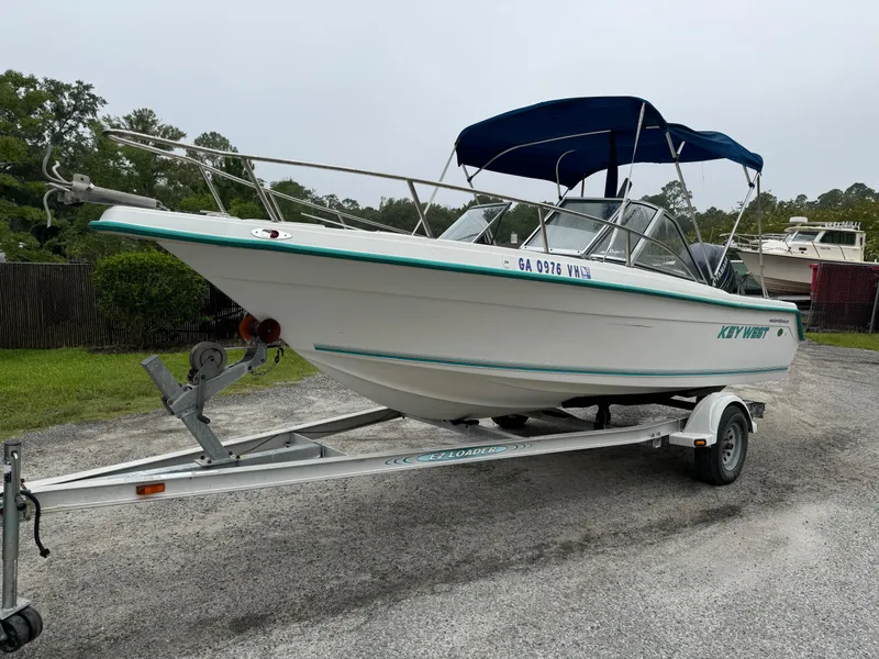 Slide: The Image of Key West 1900 Dual Console boat on trailer, 2000 model, with blue canopy. - 4
