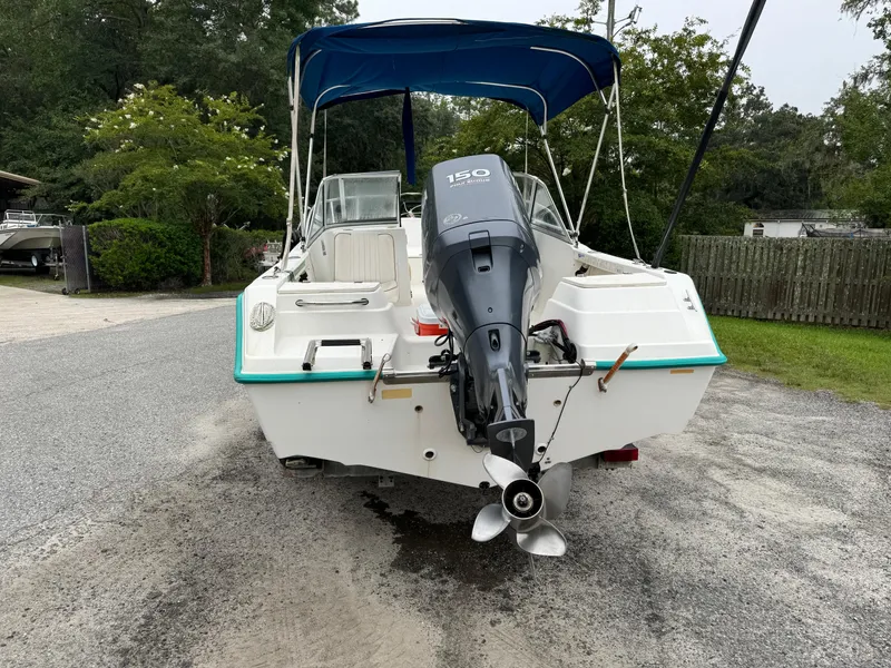 Slide: The Image of Key West 1900 Dual Console boat, 2000 model, with outboard motor and blue canopy. - 5
