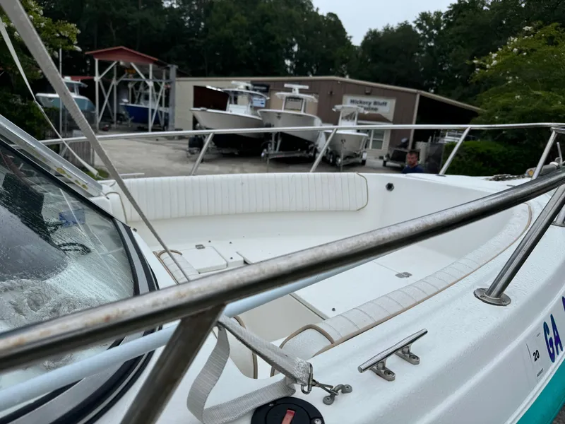 Slide: The Image of Key West 1900 Dual Console boat, 2000 model, in a marina with other boats. - 7