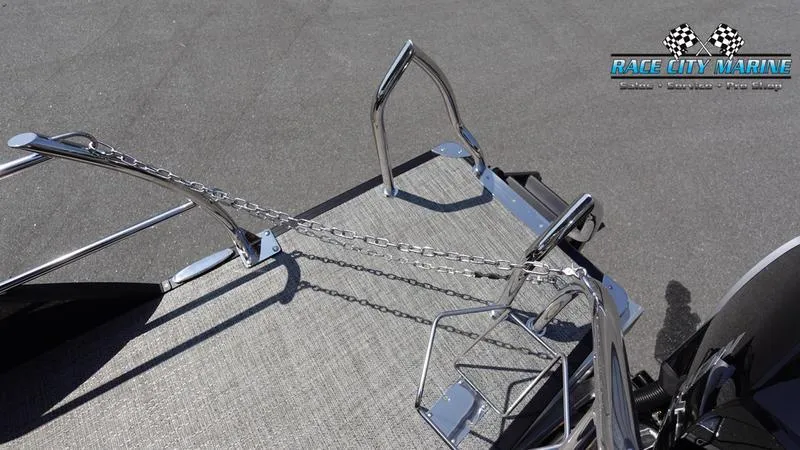 Slide: The Image of 2025 Barletta X23UC boat deck with chrome railings and Race City Marine logo. - 10