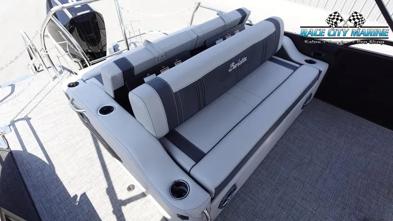 Slide: The Image of 2025 Barletta X23UC boat interior with plush seating and cup holders. - 14