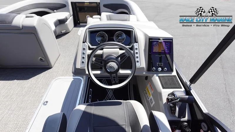 Slide: The Image of 2025 Barletta X23UC boat dashboard with steering wheel and digital display. - 19