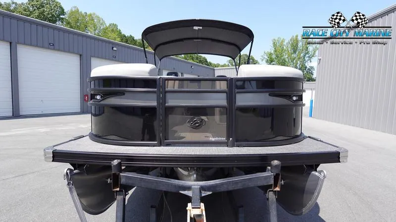 Slide: The Image of 2025 Barletta X23UC pontoon boat at Race City Marine dealership. - 2