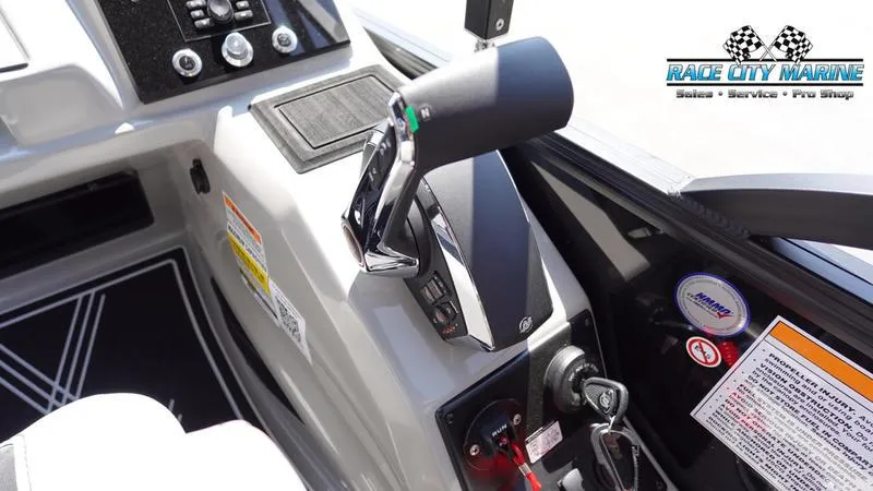 Slide: The Image of 2025 Barletta X23UC boat control panel with throttle and key ignition. - 21