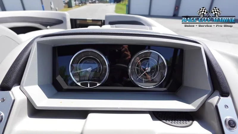 Slide: The Image of Dashboard of 2025 Barletta X23UC boat with dual gauges, Race City Marine logo. - 25