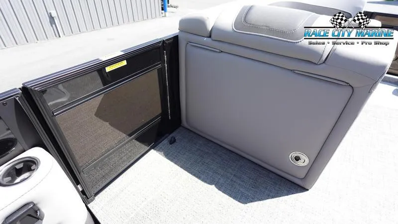 Slide: The Image of 2025 Barletta X23UC boat interior with storage compartment and seating. - 29