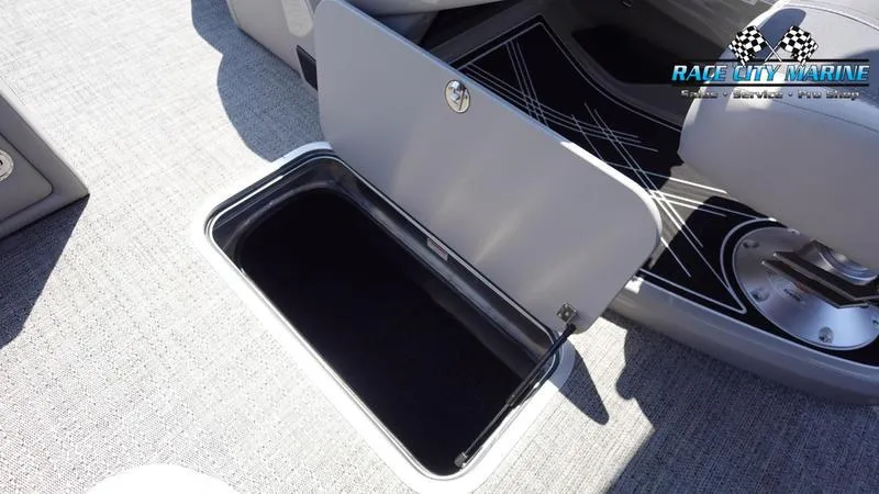 Slide: The Image of 2025 Barletta X23UC boat storage compartment with open lid, showcasing interior space. - 34