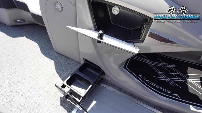 Slide: The Image of 2025 Barletta X23UC boat interior with cup holders and storage compartments. - 36