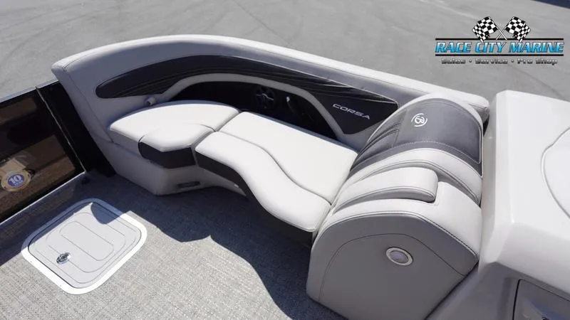 Slide: The Image of 2025 Barletta X23UC boat interior with plush seating and Race City Marine logo. - 39