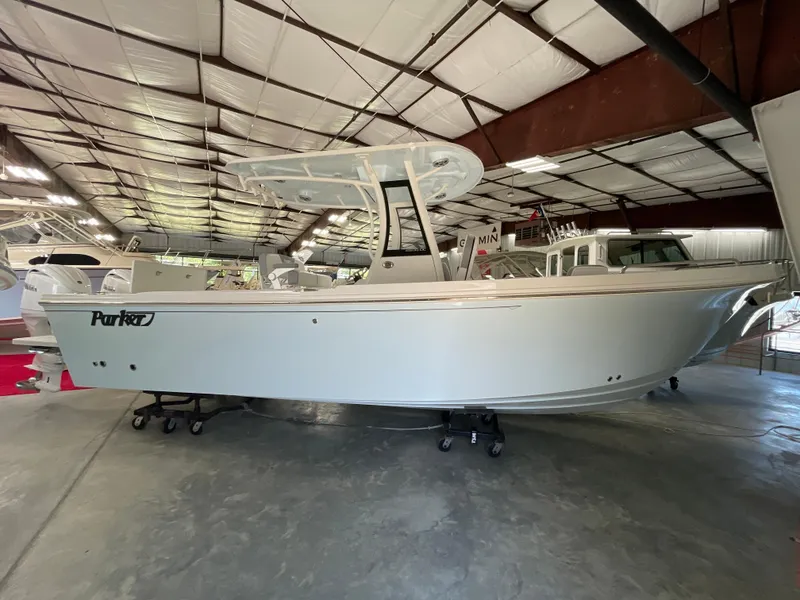 The Image of 2025 Parker 2600 Center Console boat in a spacious indoor showroom. - 0