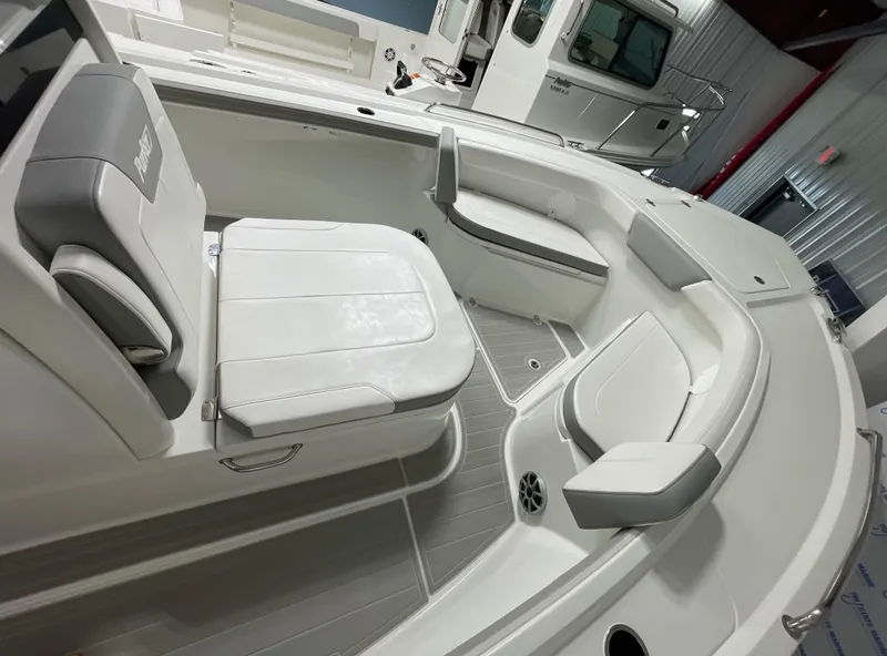 Slide: The Image of 2025 Parker 2600 Center Console boat interior with white seating and modern design. - 10