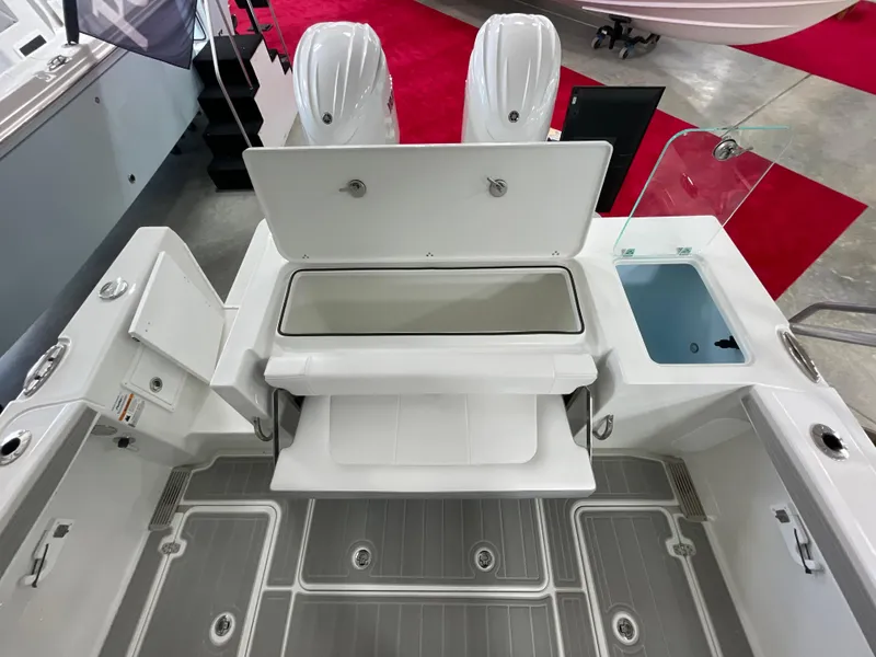 Slide: The Image of 2025 Parker 2600 Center Console boat interior with storage compartments and dual engines. - 13