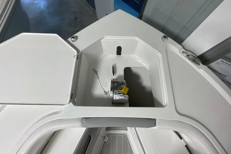 Slide: The Image of 2025 Parker 2600 Center Console boat anchor compartment, open lid, white interior. - 14