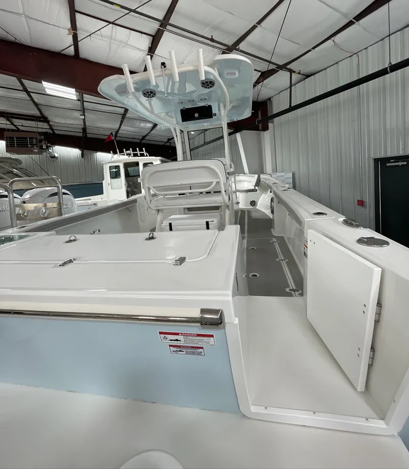 Slide: The Image of 2025 Parker 2600 Center Console boat in a warehouse, showcasing spacious deck and modern design. - 3