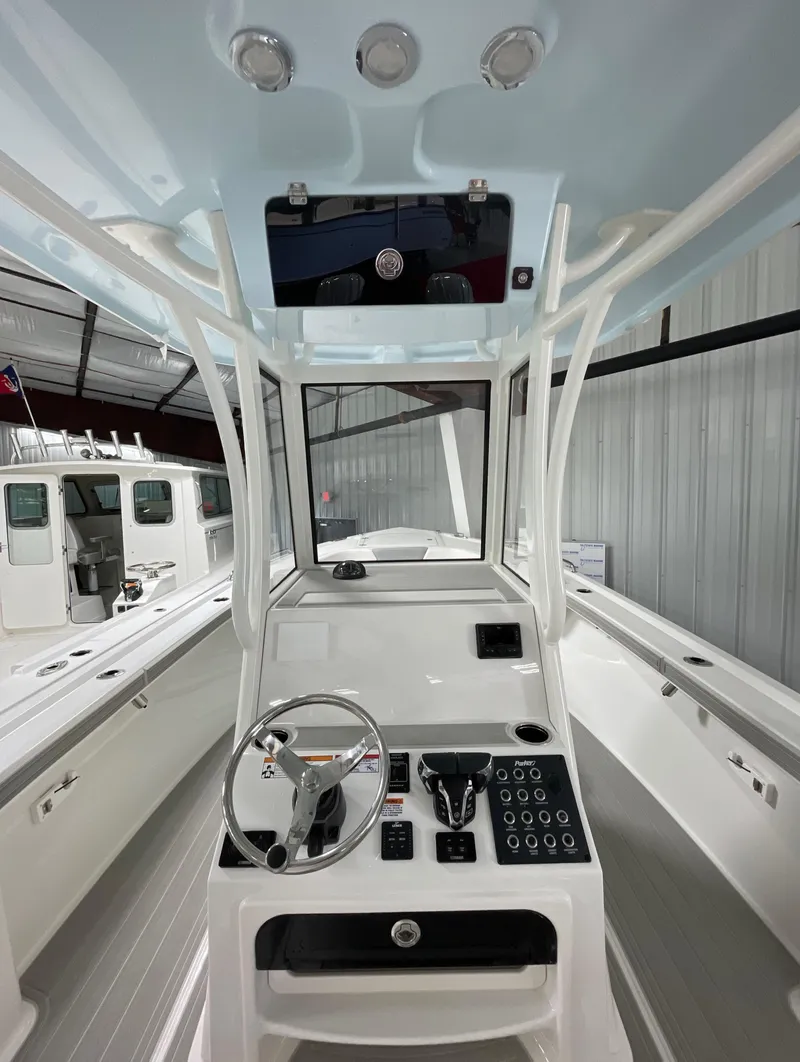 Slide: The Image of 2025 Parker 2600 Center Console boat interior with modern controls and steering wheel. - 6