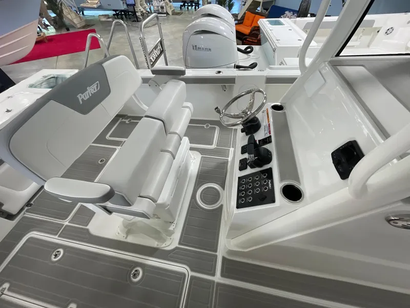 Slide: The Image of 2025 Parker 2600 Center Console boat interior with steering wheel and seating. - 7