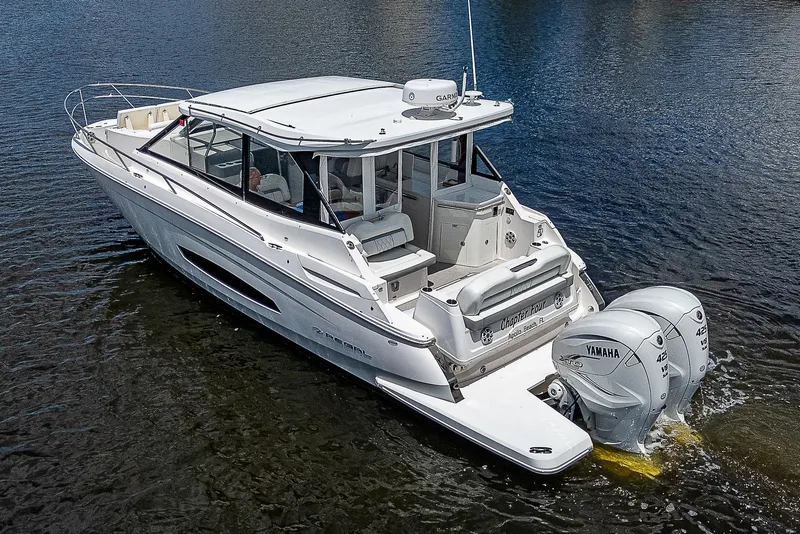 Slide: The Image of 2022 Regal 36 XO boat with twin Yamaha engines on calm water. - 0