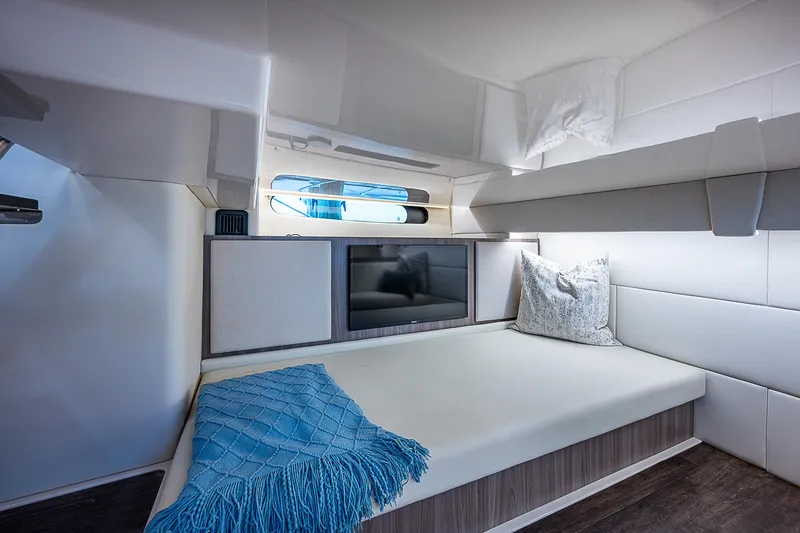 Slide: The Image of Interior cabin of 2022 Regal 36 XO yacht with cozy bed and blue blanket. - 15