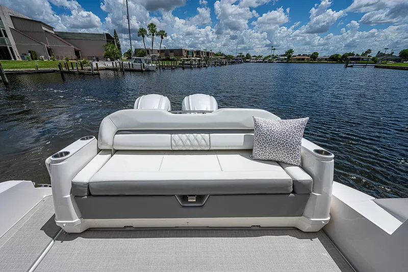 Slide: The Image of Luxury seating on 2022 Regal 36 XO boat overlooking serene waterfront. - 22