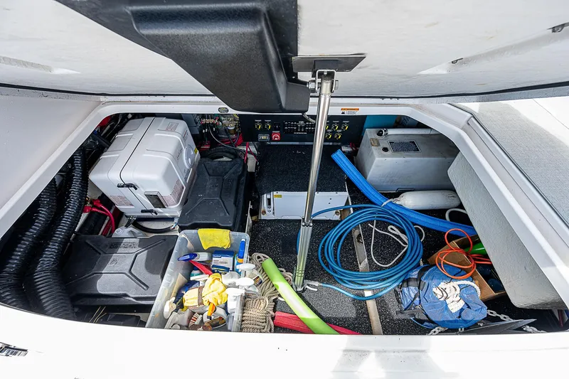 Slide: The Image of 2022 Regal 36 XO boat storage compartment with various equipment and tools. - 33