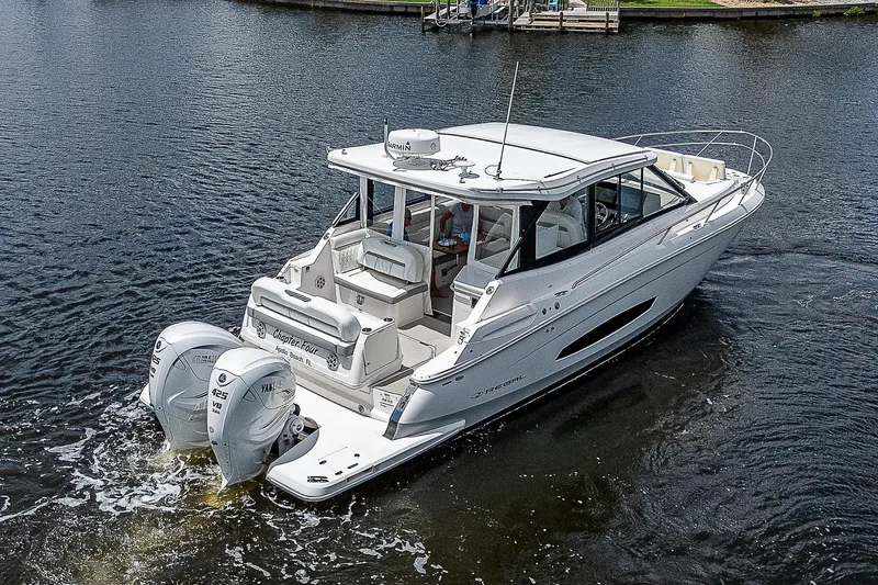 Slide: The Image of 2022 Regal 36 XO boat cruising on a calm lake. - 35