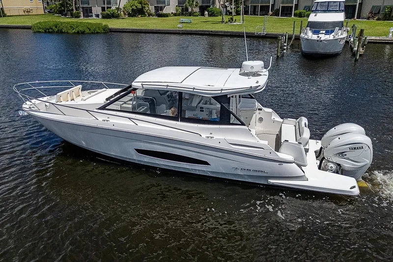 Slide: The Image of 2022 Regal 36 XO boat cruising on a calm river. - 41