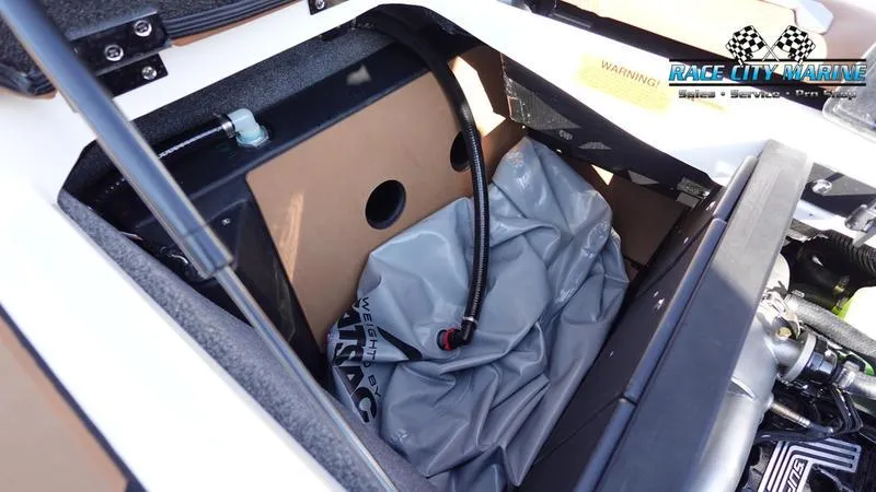 Slide: The Image of 2023 Malibu 26 LSV boat storage compartment with Race City Marine branding. - 13