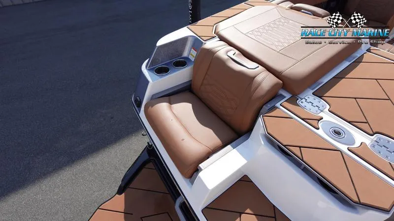 Slide: The Image of 2023 Malibu 26 LSV boat with tan seating and cup holders. - 15