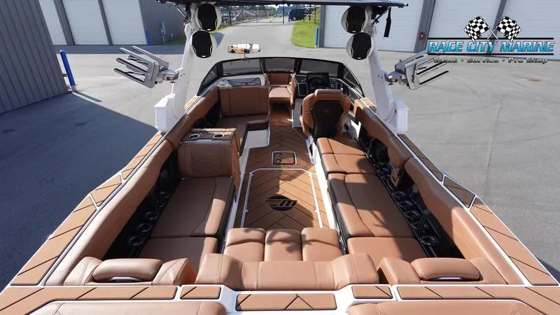 Slide: The Image of 2023 Malibu 26 LSV boat interior with luxurious brown seating and modern design. - 18