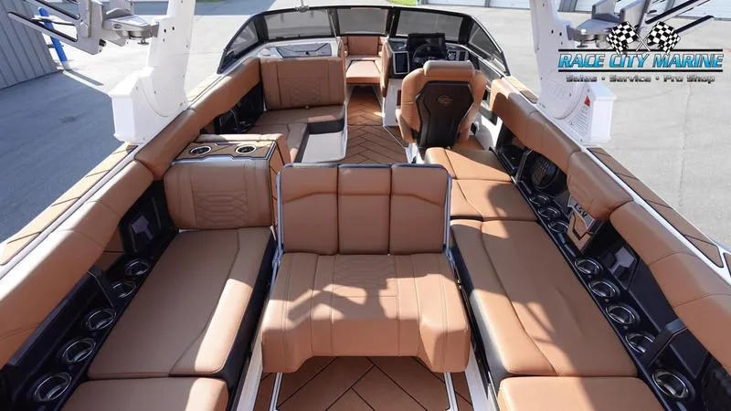 Slide: The Image of Luxurious interior of 2023 Malibu 26 LSV boat with tan leather seating. - 19