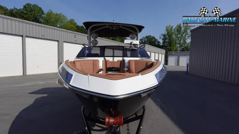 Slide: The Image of 2023 Malibu 26 LSV boat at Race City Marine dealership. - 2