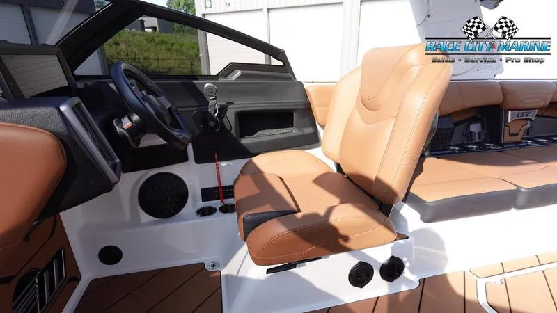 Slide: The Image of 2023 Malibu 26 LSV boat interior with tan seating and modern dashboard. - 27