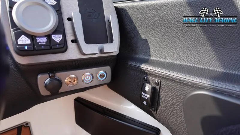 Slide: The Image of 2023 Malibu 26 LSV boat dashboard with control panel and Race City Marine logo. - 29