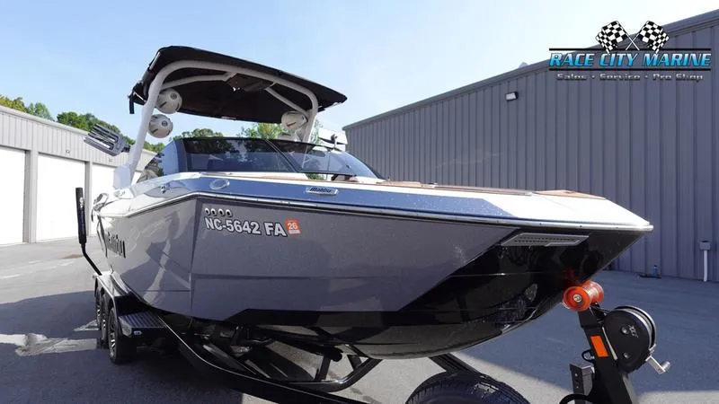 Slide: The Image of 2023 Malibu 26 LSV boat on trailer at Race City Marine dealership. - 3