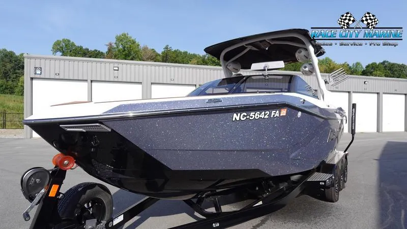 Slide: The Image of 2023 Malibu 26 LSV boat on trailer at Race City Marine dealership. - 4